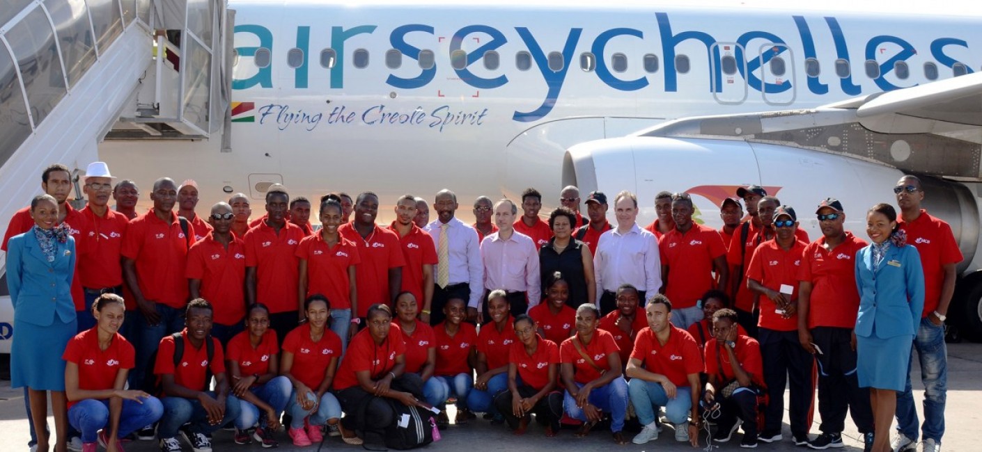 (From centre left) Vincent Meriton, Minister for Social Affairs, Community Development and Sports, Joël Morgan, Minister of Foreign Affairs and Transport and Chairman of Air Seychelles, Giovanna Rousseau, Chief Executive Officer of the National Sports Council and Roy Kinnear, Chief Executive Officer of Air Seychelles, pose with the national volleyball team for a souvenir photograph before their afternoon flight to Réunion